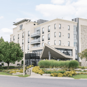 Modern hotel exterior with landscaped entrance.